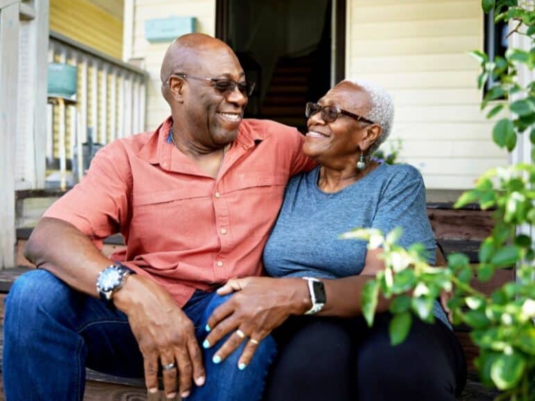 Senior couple sitting on their porch